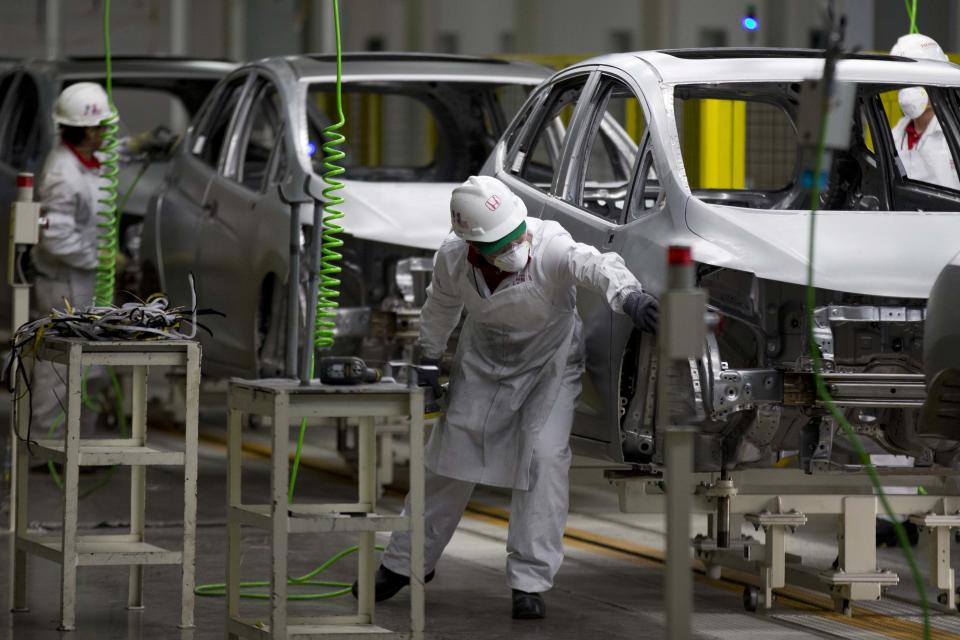 Employees at work in the new multibillion-dollar Honda car plant in Celaya, in the central Mexican state of Guanajuato, Friday, Feb. 21, 2014. Mexico is on track to overtake Japan and Canada and become the United States' No. 1 source of imported cars by the end of next year, part of a national manufacturing boom that has turned the auto industry into a bigger source of dollars than money sent home by migrants.(AP Photo/Eduardo Verdugo)