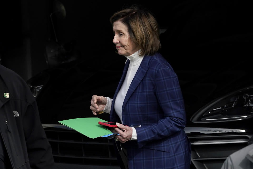 House Speaker Nancy Pelosi is escorted to a vehicle outside of her home in San Francisco, Friday, Nov. 4, 2022. (AP Photo/Jeff Chiu)