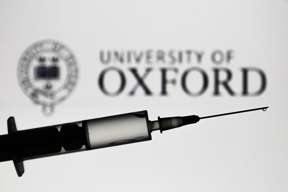 Medical syringe is seen with University of Oxford logo displayed on a screen in the background in this illustration photo taken in Poland on November 16, 2020. (Photo by Jakub Porzycki/NurPhoto via Getty Images)