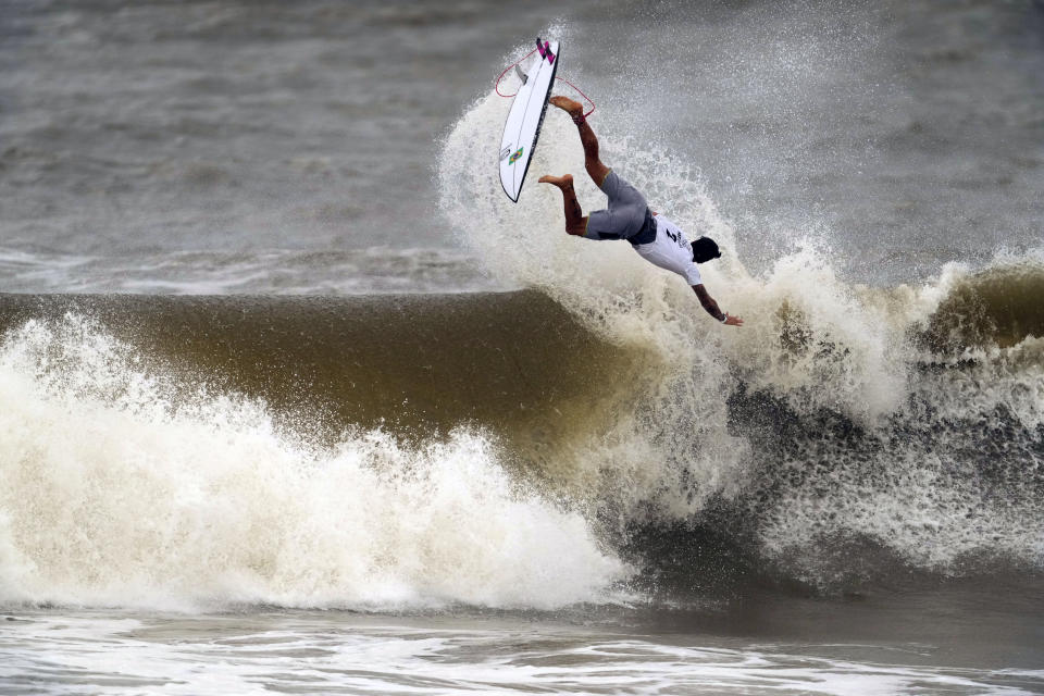 Brazil's Gabriel Medina goes to the air on a wave during the semifinals of the men's surfing competition at the 2020 Summer Olympics, Tuesday, July 27, 2021, at Tsurigasaki beach in Ichinomiya, Japan. (AP Photo/Francisco Seco)