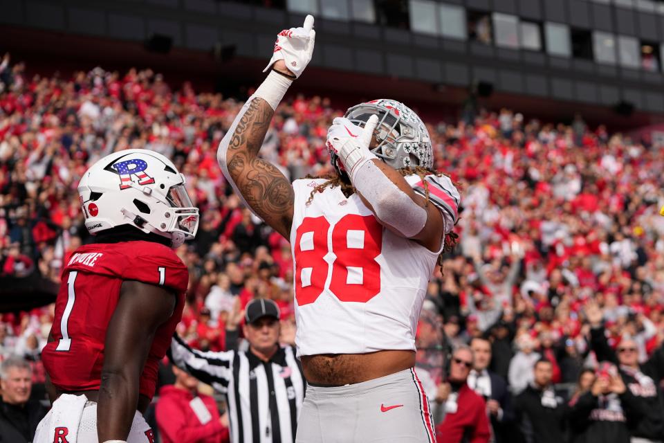 Nov 4, 2023; Piscataway, New Jersey, USA; Ohio State Buckeyes tight end Gee Scott Jr. (88) celebrates a touchdown in front of Rutgers Scarlet Knights linebacker Mohamed Toure (1) during the first half of the NCAA football game at SHI Stadium.