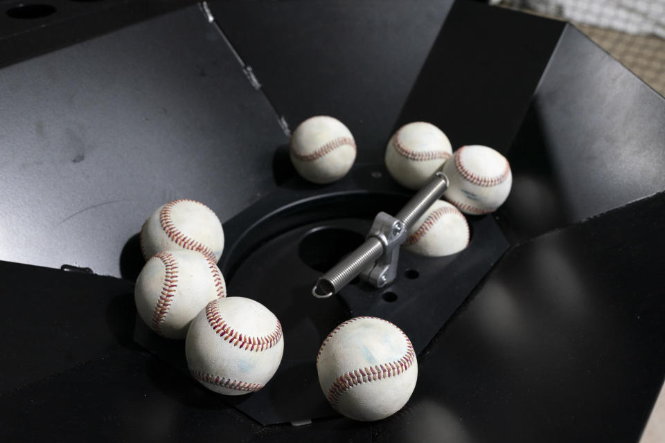 Baseballs wait to be sent through The Trajekt Arc pitching machine as the device is demonstrated during the Major League Baseball winter meetings Wednesday, Dec. 6, 2023, in Nashville, Tenn. (AP Photo/George Walker IV)