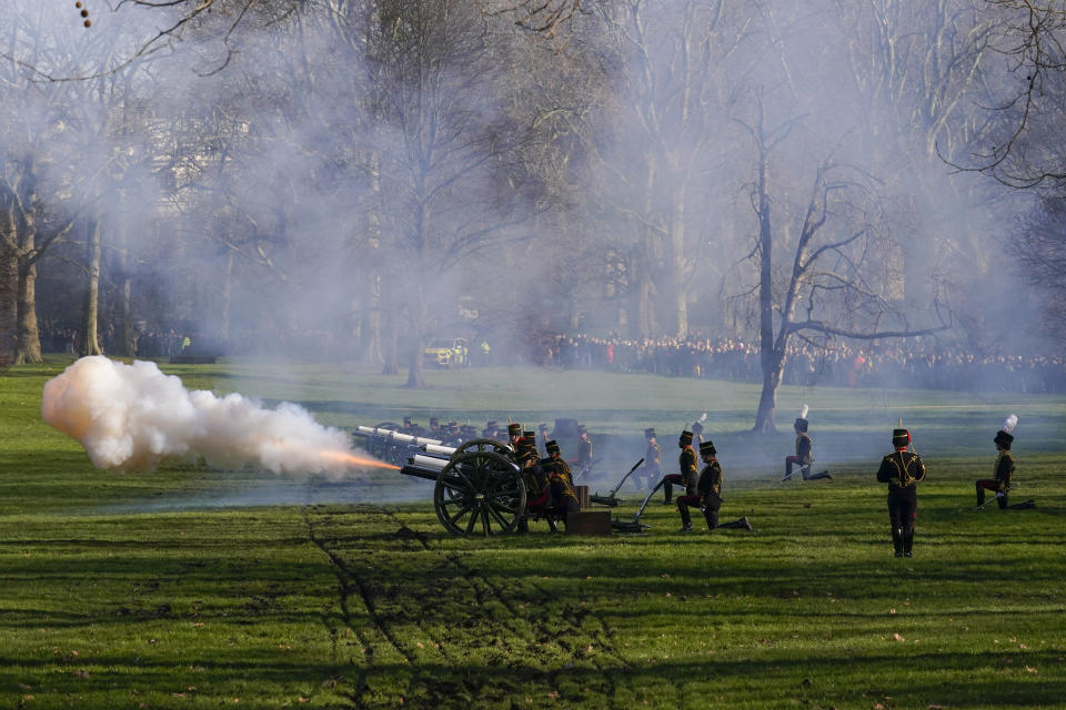 Fire shrouds the scene as The King's Troop Royal Horse Artillery fire gun salutes to mark the 70th anniversary of the accession to the throne of Britain's Queen Elizabeth, in Green Park beside Buckingham Palace, London, Monday, Feb. 7, 2022. Queen Elizabeth II acceded to the throne on the death of her father King George VI on Feb. 6, 1952. (AP Photo/Alberto Pezzali)