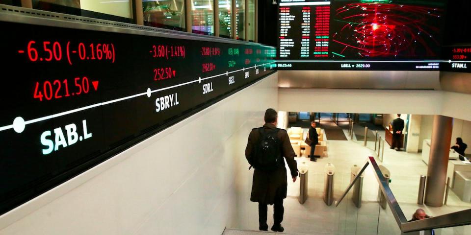 People walk through the lobby of the London Stock Exchange in London, Britain November 30, 2015