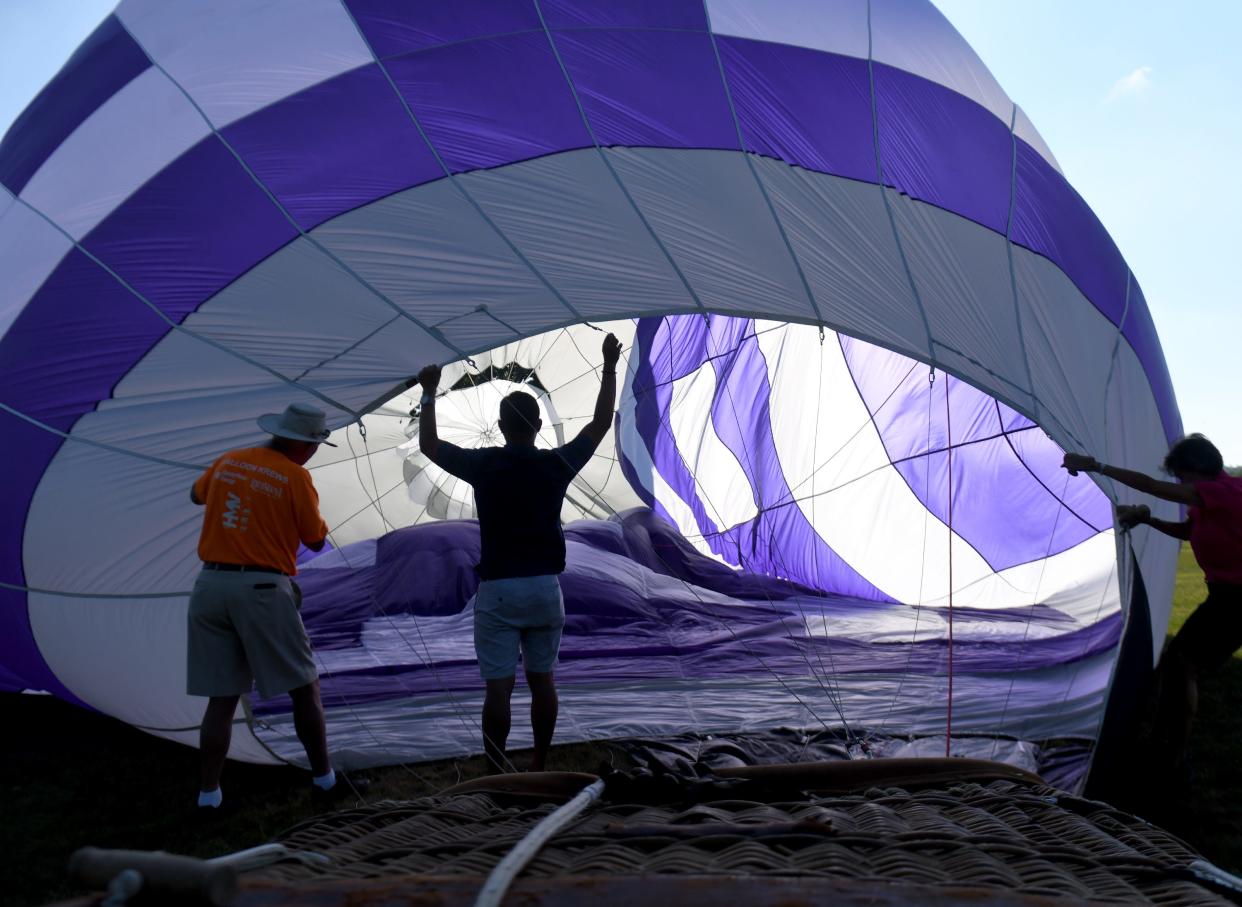 Ben Miller of Alliance, center, who has loved hot air balloons since he was 5, is assistant chair of the Pro Football Hall of Fame Balloon Classic. In 2019, Miller built his own balloon, which he christened "Twin Blessings" to honor his daughters. Dad Bill Miller is at left.