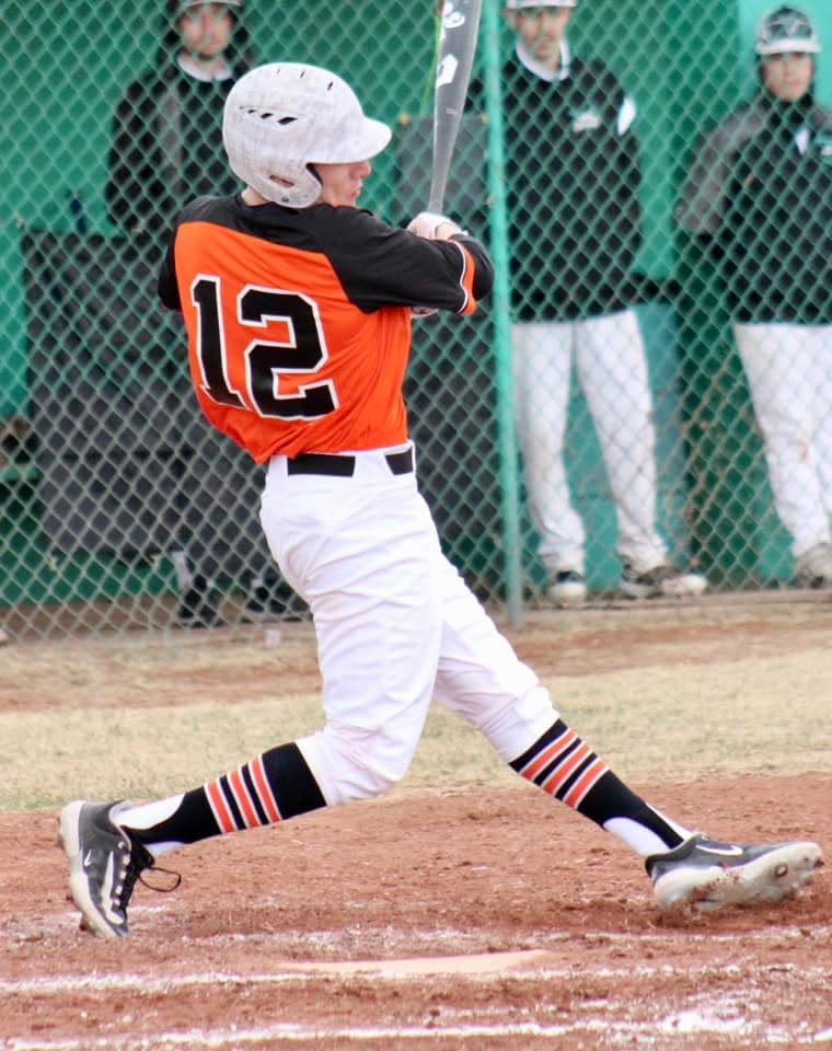 Aztec High School's Logan Austin records one of his three hits during a game against Capital in the first round of the Moriarty Invitational, Thursday, March 23, 2023.