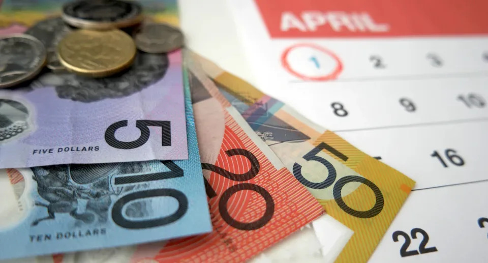 Insurance rise date circled on a calendar and Australian money scattered on top.