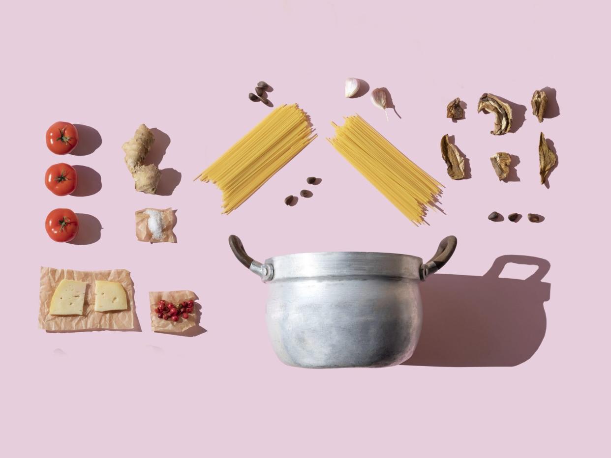 Italian pasta ingredients on the pink background knolling