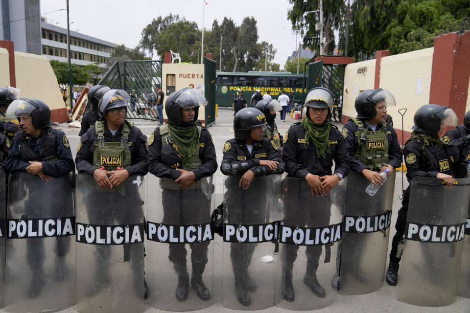 Police guard the San Marcos University in Lima, Peru, Saturday, Jan. 21, 2023. Police evicted from the university grounds protesters who arrived from Andean regions seeking the resignation of President Dina Boluarte, the release from prison of ousted President Pedro Castillo and immediate elections. (AP Photo/Martin Mejia)