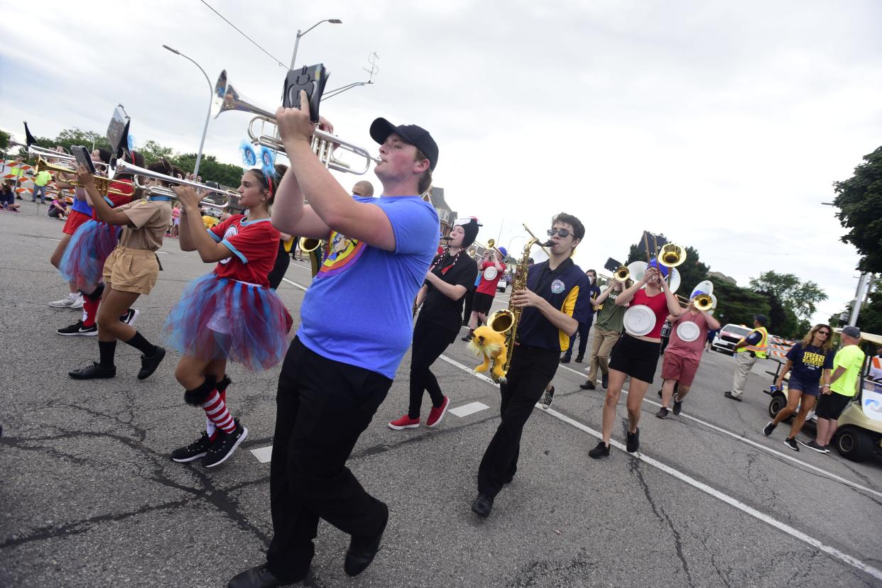 Members of Port Huron Northern's marching band march alone Huron Avenue during the annual Rotary International Day Parade to kick off Port Huron's Boat Week on Wednesday, July 13, 2022.