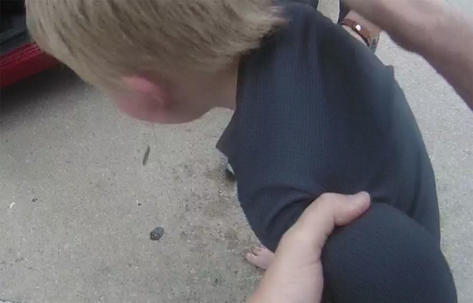 An officer helps a choking three-year-old boy. Source: Pottawatomie County Sheriff’s Office via Storyful