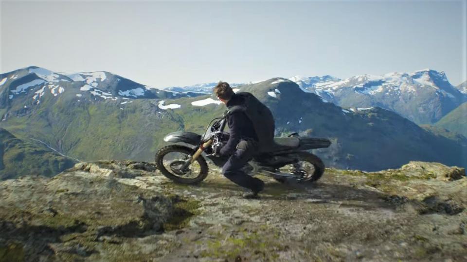 ethan hunt rides a motorcycle to the edge of a cliff in a scene from mission impossible dead reckoning part one dead reckoning part two is the eighth film if you're watching the mission impossible movies in order, and it will come out in 2024