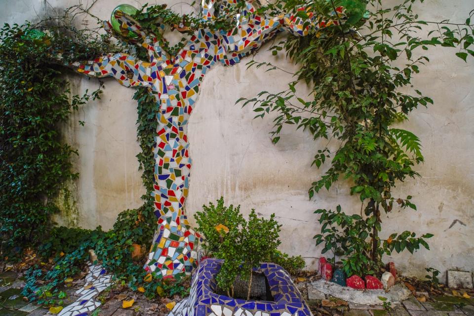 A tree on the outside of the livable art sculpture Airbnb in Rome