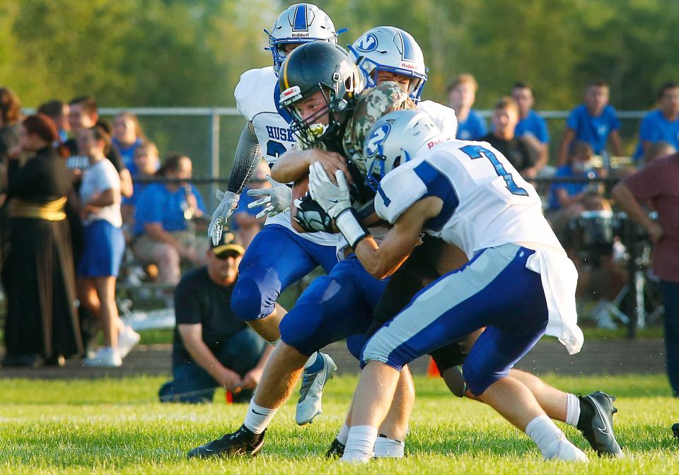 Black River High School's Joseph McKean (30) is tackled by Northwestern High School's Ethan Siders (8) and Craig Reed (7) Friday, Aug. 27, 2021. NOELLE BYE/FOR TIMES-GAZETTE.COM