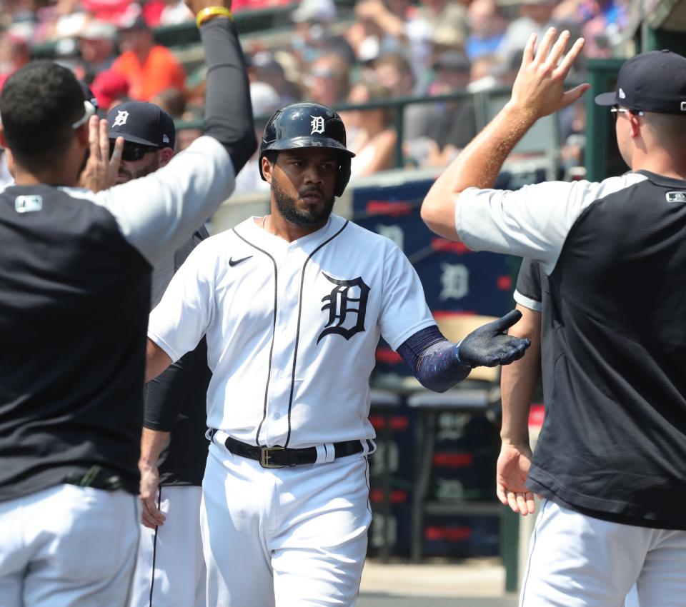 Tigers third baseman Jeimer Candelario is met by teammates after scoring against the Angels during the first inning at Comerica Park on Thursday, Aug. 19, 2021.