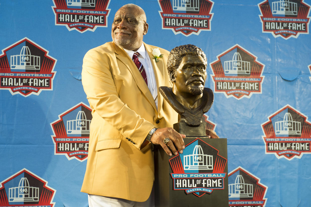 Former NFL defensive end Claude Humphrey with his bust during the NFL Class of 2014 Pro Football Hall of Fame Enshrinement Ceremony