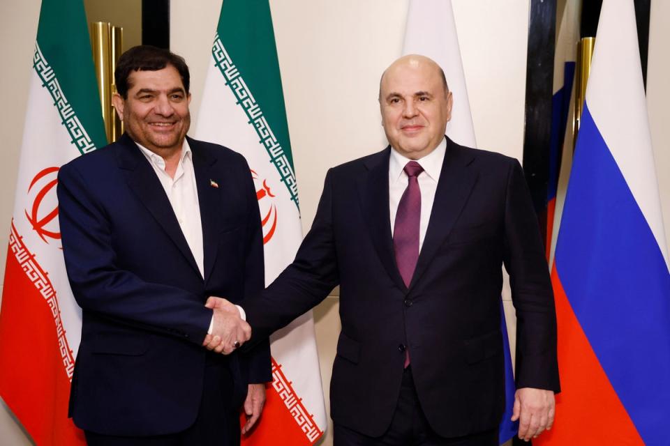Iranian First Vice-President Mohammad Mokhber (left) shakes hands with Russian Prime Minister Mikhail Mishustin during a meeting in October 2023 (AP)