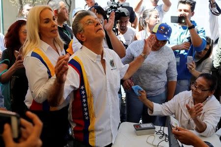 FILE PHOTO: Henry Ramos Allup, lawmaker of Democratic Action (Accion Democratica), gestures after taking part in the National Electoral Council (CNE) process for validation of parties in Caracas, Venezuela January 27, 2018. REUTERS/Marco Bello/File Photo
