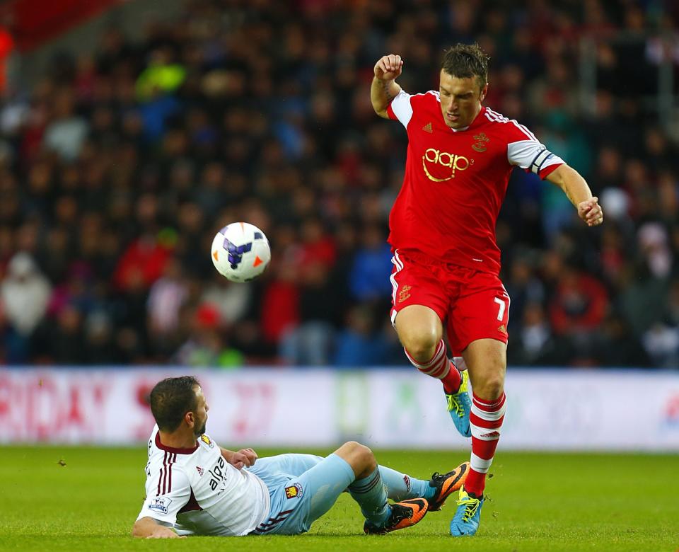 Southampton's Rickie Lambert (right) is tackled by West Ham United's Razvan Rat 