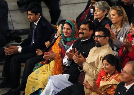 Family members of Nobel Peace Prize laureates Malala Yousafzai and Kailash Satyarthi applaud during the Nobel Peace Prize awards ceremony at the City Hall in Oslo December 10, 2014. REUTERS/Suzanne Plunkett