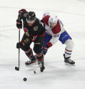 Montreal Canadiens defenseman Jordan Harris (54) battles for control of the puck with Ottawa Senators left wing Jiri Smejkal during second-period NHL hockey game action in Ottawa, Ontario, Saturday, April 13, 2024. (Adrian Wyld/The Canadian Press via AP)