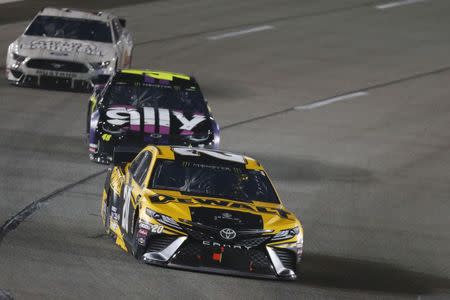 Apr 13, 2019; Richmond, VA, USA; Monster Energy NASCAR Cup Series driver Erik Jones (20) races Cup Series driver Jimmie Johnson (48) and Cup Series driver Aric Almirola (10) during the Toyota Owners 400 at Richmond International Raceway. Amber Searls-USA TODAY Sports