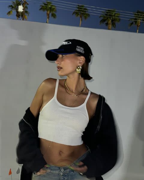 Hailey Bieber gives a hint of midriff in crop top and flared pants during  flurry of selfie photos