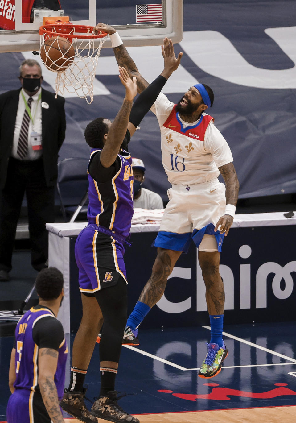 New Orleans Pelicans forward James Johnson (16) dunks over Los Angeles Lakers center Andre Drummond (2) in the first quarter of an NBA basketball game in New Orleans, Sunday, May 16, 2021. (AP Photo/Derick Hingle)