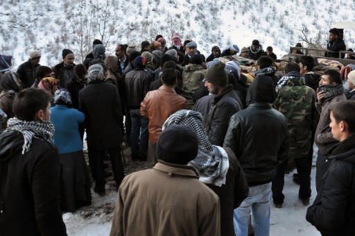 Locals gather in front of a truck carrying the bodies of people who were killed in a warplane attack in the Ortasu village of Uludere, in the Sirnak province. Turkish fighter jets killed 35 Kurds in an air strike the country's ruling party admitted Thursday could have been a "blunder" that mistakenly hit civilians instead of Kurdish separatists