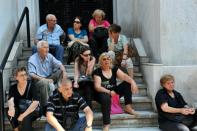 Pensioners wait outside a closed branch of the Greek National bank in Thessaloniki on June 29, 2015 after Greece ordered its banks to shut for one week and imposed capital controls