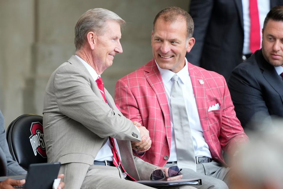 Aug 30, 2024; Columbus, OH, USA; Ohio State president Ted Carter and athletic director Ross Bjork attend the unveiling of a statue for former Buckeyes running back Archie Griffin outside Ohio Stadium.