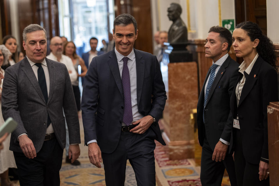 Spain's Prime Minister Pedro Sanchez, center, arrives at the Spanish parliament's lower house in Madrid on Thursday, May 30, 2024. Spain's Parliament has given final approval to a controversial amnesty law for hundreds of Catalan separatists involved in the illegal and unsuccessful 2017 secession bid. The legislation was backed in the lower house by Spain's left-wing coalition government, two Catalan separatist parties, and other smaller parties. It passed despite the conservative Popular Party and far-right Vox voting against it. (AP Photo/Bernat Armangue)