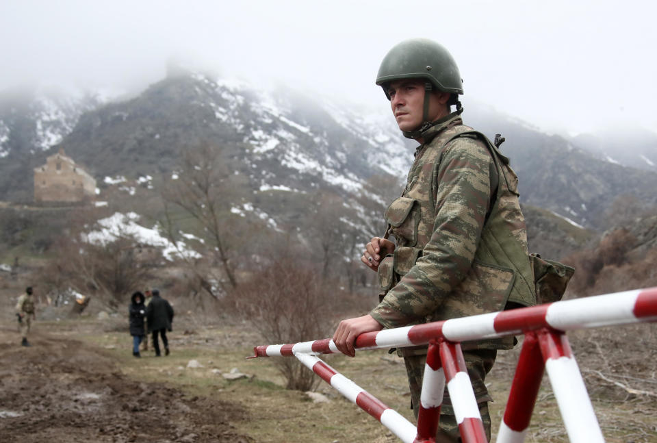 An Azerbaijani serviceman is seen at the Agaoglan Monastery in Lachin District, in the disputed, but Azerbaijani-controlled Caucasus Mountains territory of Nagorno-Karabakh, February 24, 2021. / Credit: Valery Sharifulin/TASS/Getty