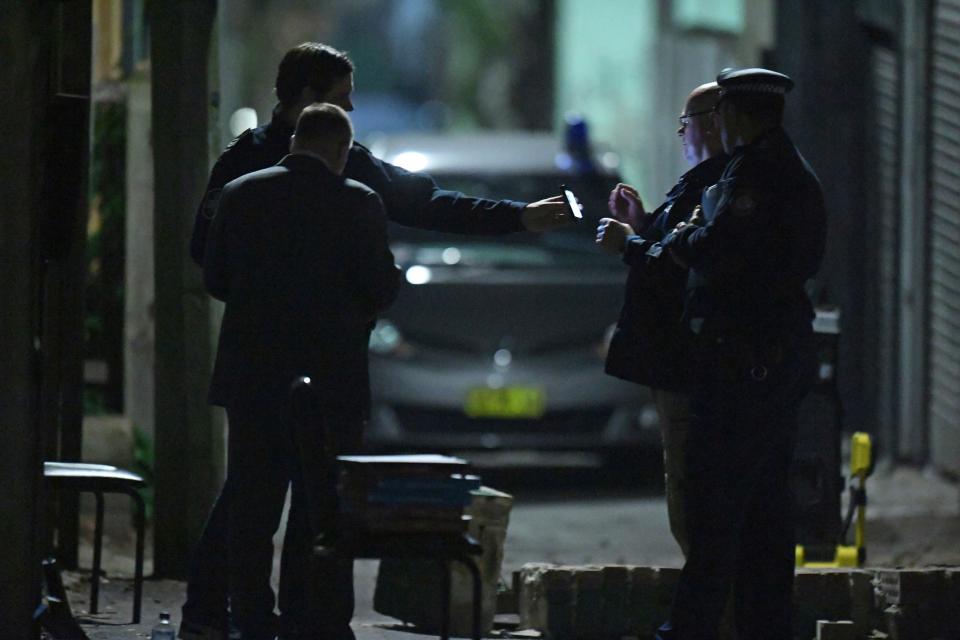 Australian Federal Police and NSW Police officers work in the Surry Hills suburb of Sydney. - Credit: Sam Mooy/AP