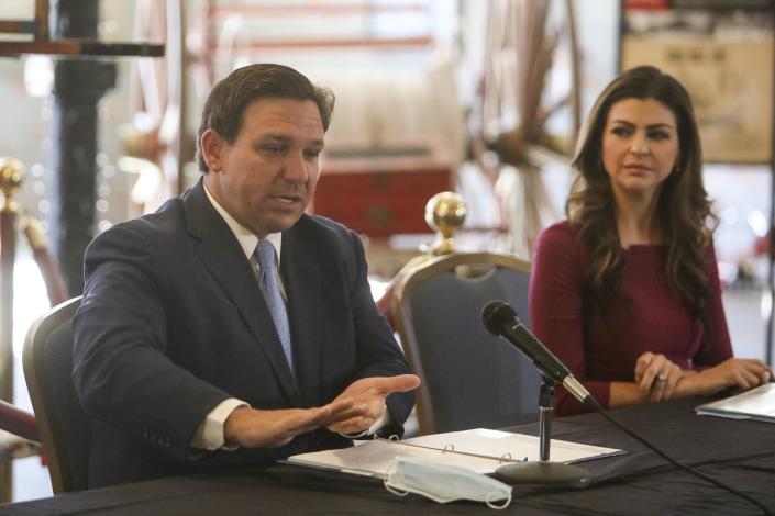 Gov. Ron DeSantis answers questions while First Lady Casey DeSantis listens at a mental health symposium in Tampa.
