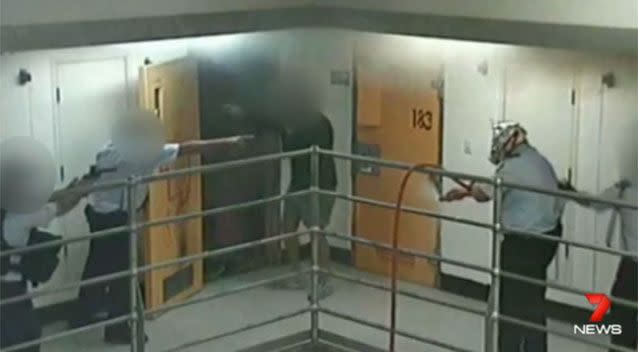 One prisoner emerges from the smoke-filled cell. Photo: 7 News