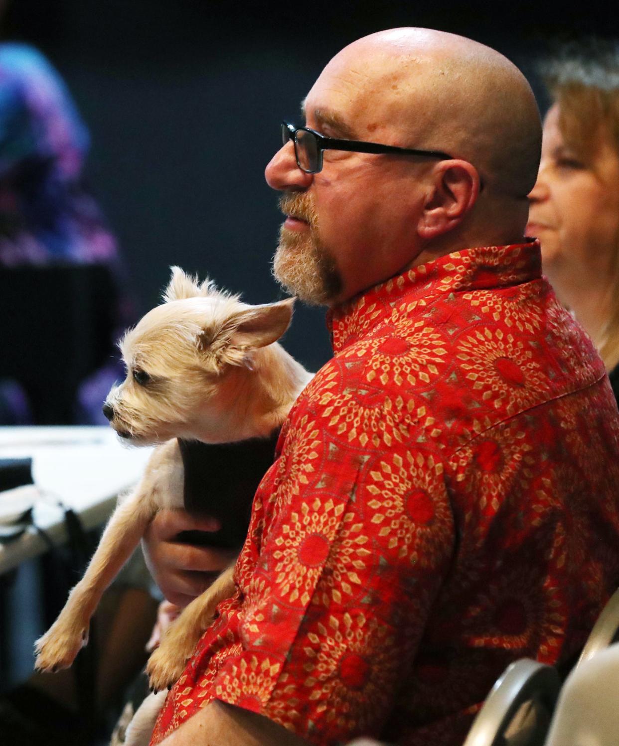 Director Warren Scott Friedman and his dog, Beau, watch a rehearsal for the All-City Musical "Oklahoma!" at Guzzetta Hall at the University of Akron's Sandefur Theatre.