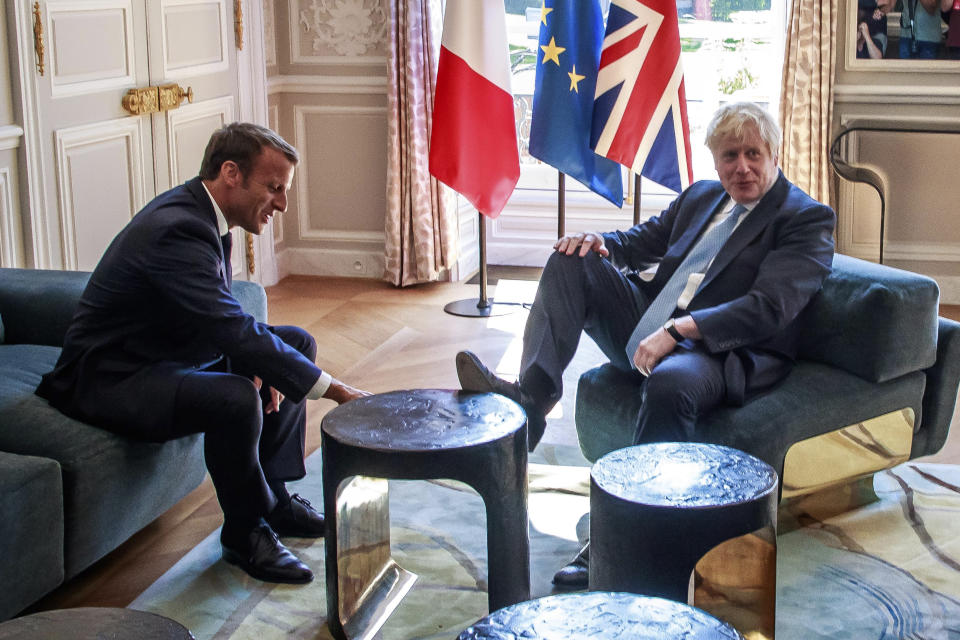 French President Emmanuel Macron, left, talks to Britain's Prime Minister Boris Johnson during their meeting at the Elysee Palace, Thursday, Aug. 22, 2019 in Paris. Boris Johnson traveled to Berlin Wednesday to meet with Chancellor Angela Merkel before heading to Paris to meet with French President Emmanuel Macron. (Christophe Petit Tesson, Pool via AP)