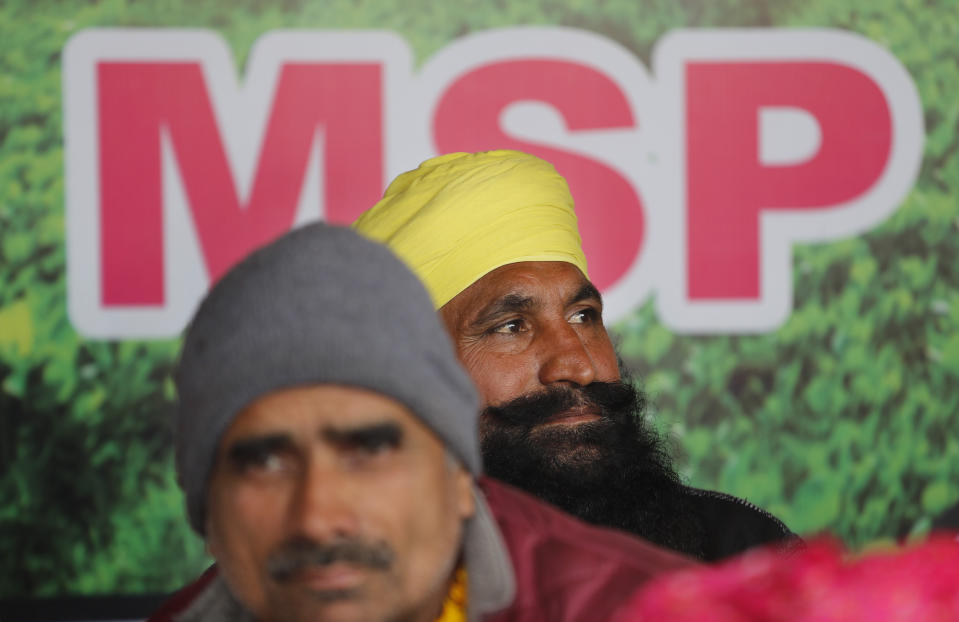 Farmers participate in a day-long hunger strike to protest against new farm laws, at the Delhi-Uttar Pradesh border, on the outskirts of New Delhi, India, Saturday, Jan. 30, 2021. Indian farmers and their leaders spearheading more than two months of protests against new agriculture laws began a daylong hunger strike Saturday, directing their fury toward Prime Minister Narendra Modi and his government. Farmer leaders said the hunger strike, which coincides with the death anniversary of Indian independence leader Mahatma Gandhi, would reaffirm the peaceful nature of the protests. (AP Photo/Manish Swarup)