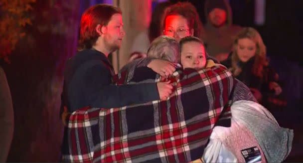 PHOTO: People react at the scene where a small plane crashed into a multifamily building in the evening of Oct. 21, 2022 in Keene, N.H. (WCVB)