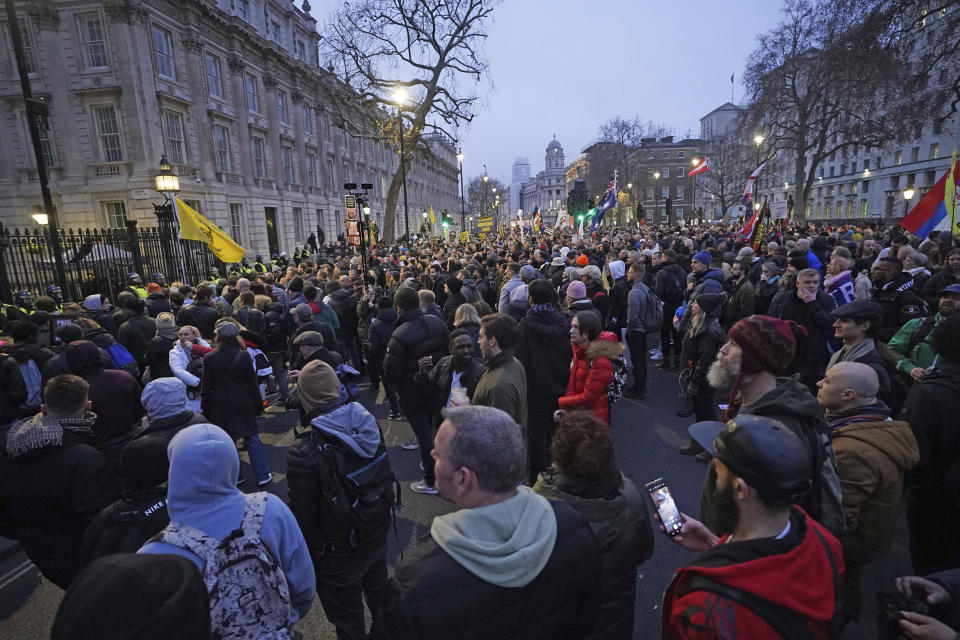 Anti -COVID-19 vaccination protesters demonstrate on Whitehall near Downing Street, in London, Saturday, Dec. 18, 2021. Hundreds of people protested in London Saturday, blocking traffic as they marched with signs bearing slogans such as “Vaccine passports kill our freedoms” and “Don’t comply.” (Ian West/PA via AP)