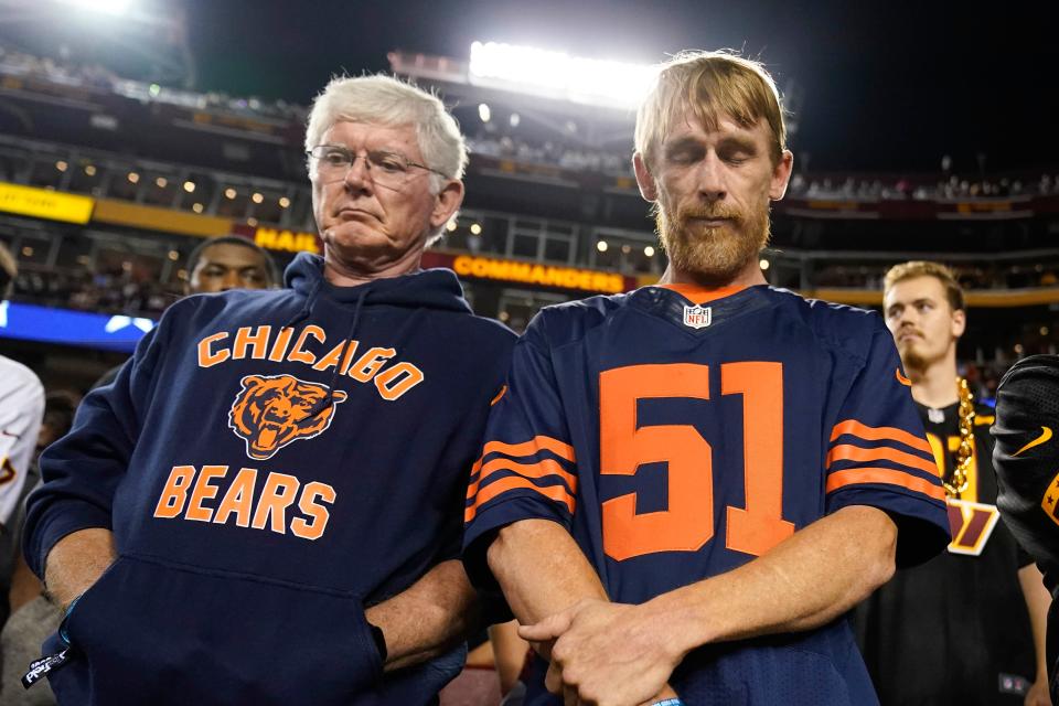 Chicago Bears fans stand during a moment of silence before the start of the game between the Washington Commanders and Chicago Bears honoring Dick Butkus, the fearsome linebacker for the Bears who passed away.