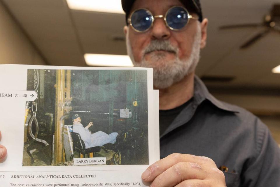 Larry Burgan shows a photo of him in the 1980s working with his feet perched upon a machine while working at the Venice-Madison site when it was owned by Spectrulite Consortium Inc.