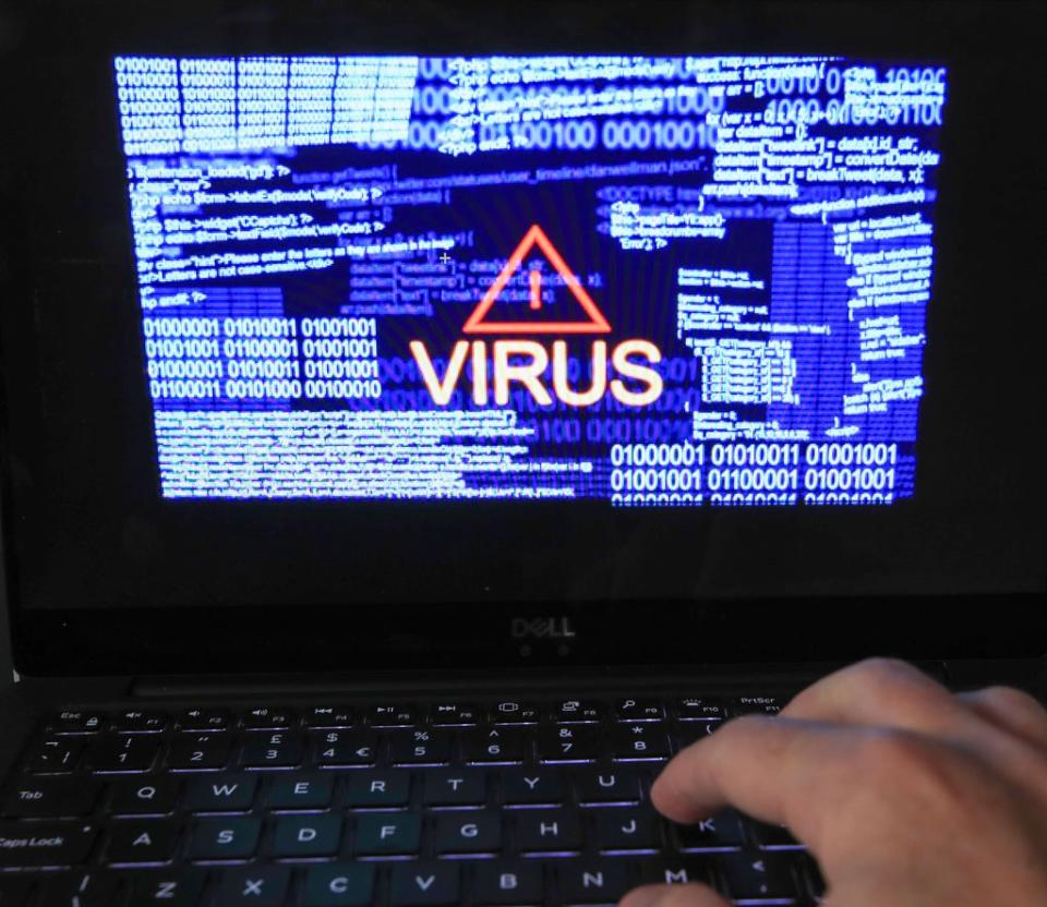 A laptop screen showing a computer virus warning (PA) (PA Archive)