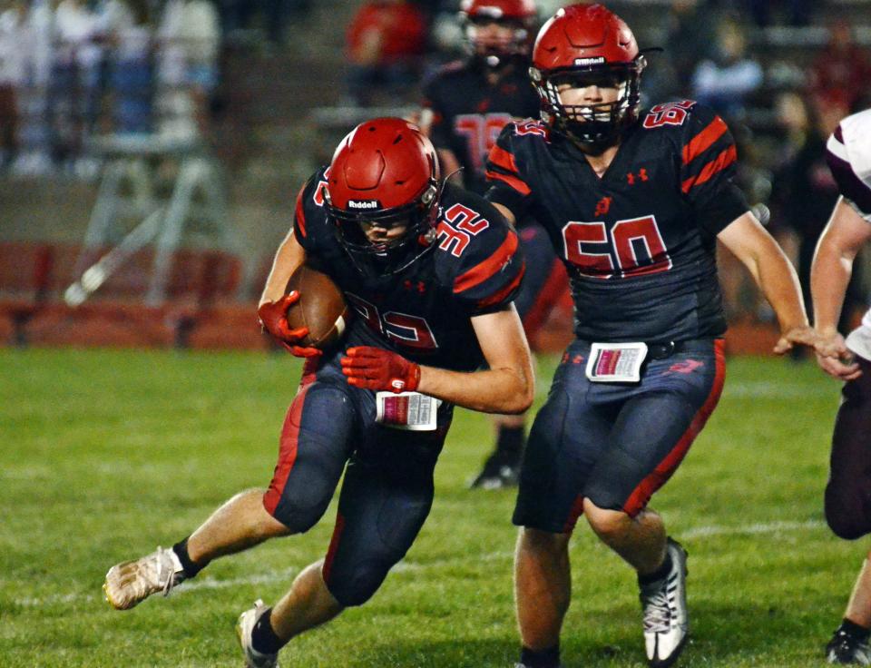 Logan Shooks (32) and Ben Reid (60), East Jordan.