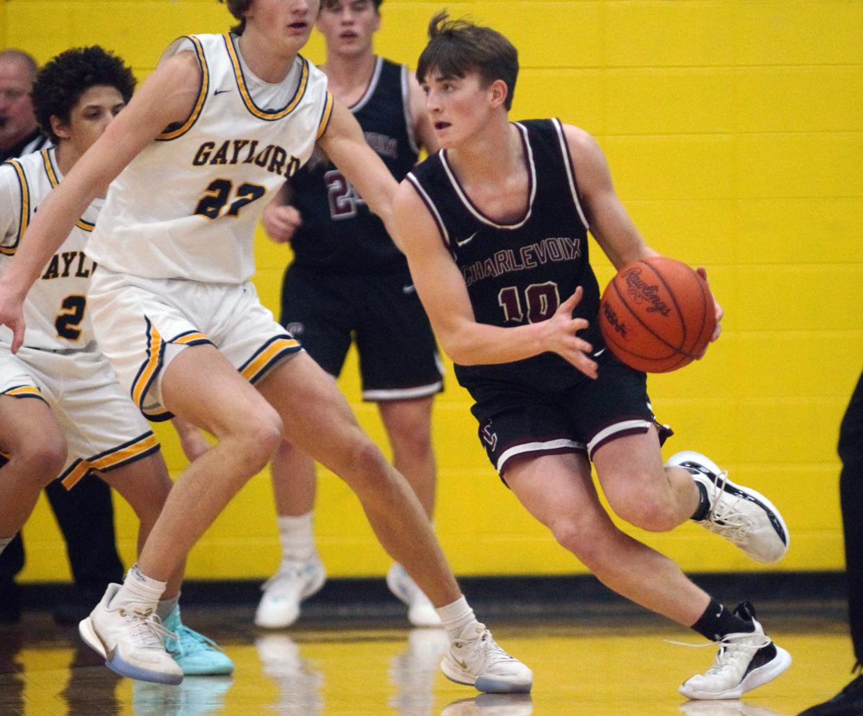 Charlevoix's Troy Nickel drives around a Gaylord player during Tuesday's season opener in Gaylord.