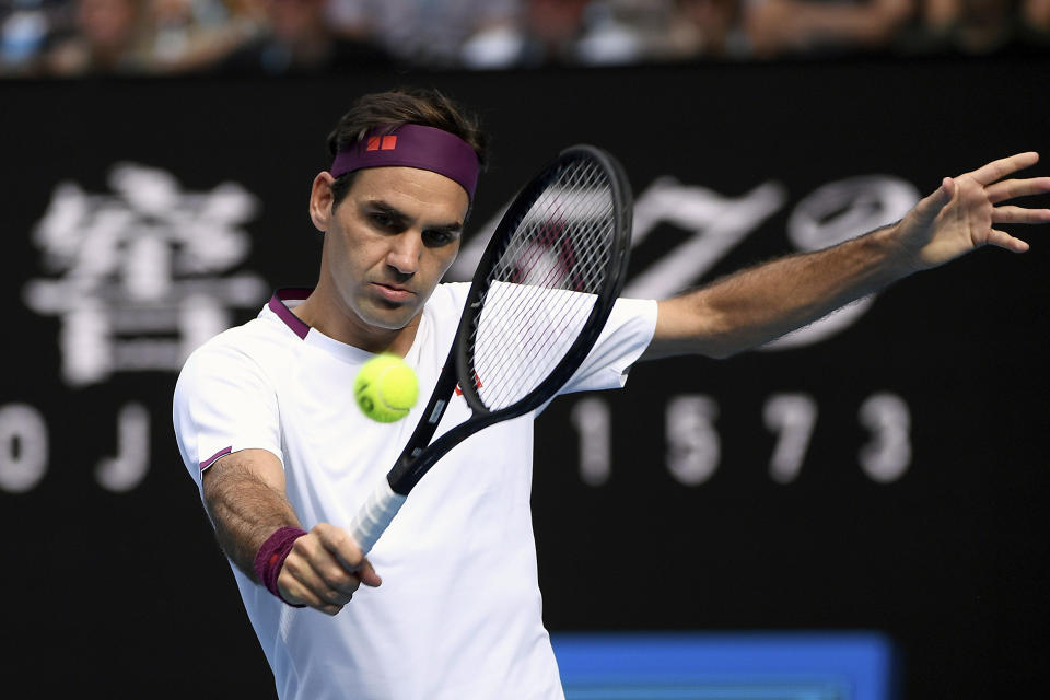 FILE - In this Jan. 28, 2020, file photo, Switzerland's Roger Federer makes a backhand return to Tennys Sandgren, of the United States, during their quarterfinal match at the Australian Open tennis championship in Melbourne, Australia. Federer is back on tour after more than a year away. (AP Photo/Andy Brownbill, File)
