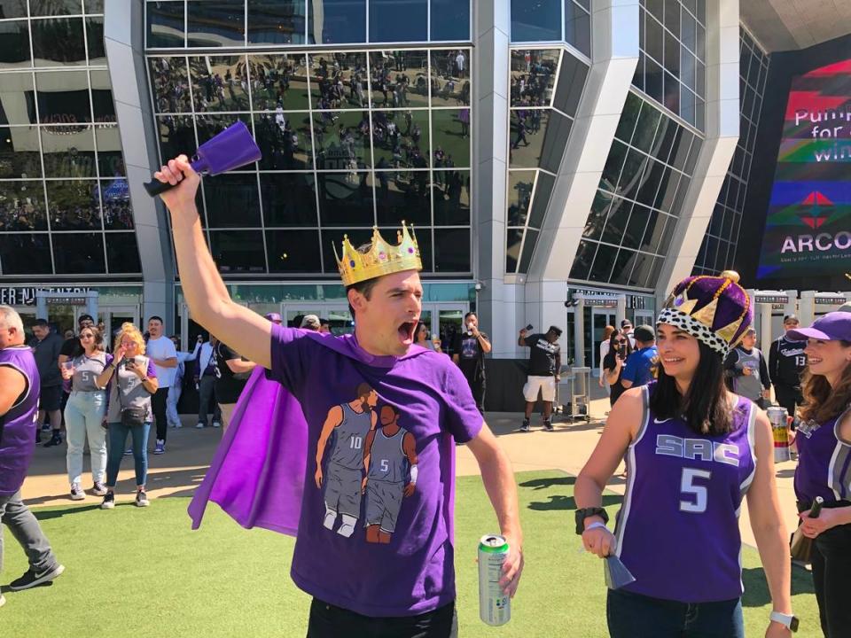 Sacramento Kings fans Brian and Micaela Birt, of Davis, wear crowns and ring their cowbells at Downtown Commons before the Kings play the Golden State Warriors the first game of their NBA playoffs series on Saturday, April 15, 2023.