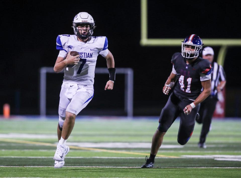 Lexington Christian's Cutter Boley scrambles for yardage from CAL's Nathan Ehrenborg in the fourth quarter to help set up an Eagle score in Louisville Friday evening. Sept. 8, 2023.