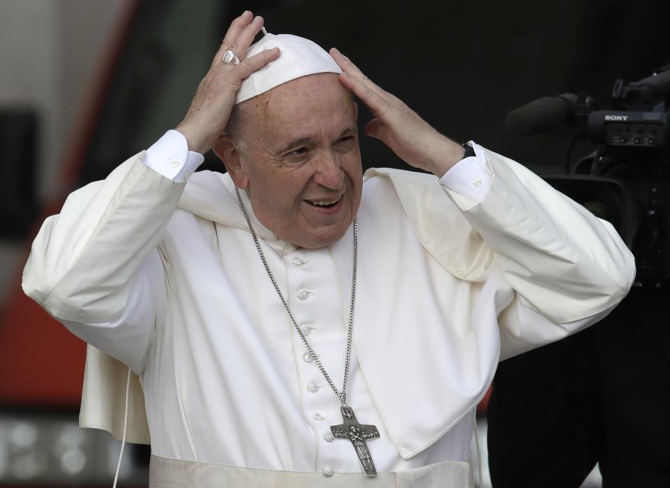 Pope Francis holds on to his skull cap so that it doesn't blow away with the wind as he arrives for his weekly general audience, in St. Peter's Square at the Vatican, Wednesday, May 29, 2019. (AP Photo/Alessandra Tarantino)